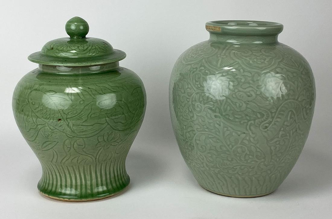 (on 2) CHINESE CELEDON PORCELAINS: Ming mark on outside rim, JAR with (2) inscribed dragons in overall scrolling vine design 11"h; opening 5"; along with another COVERED JAR with inscribed fish and lotus design, 11.5"h