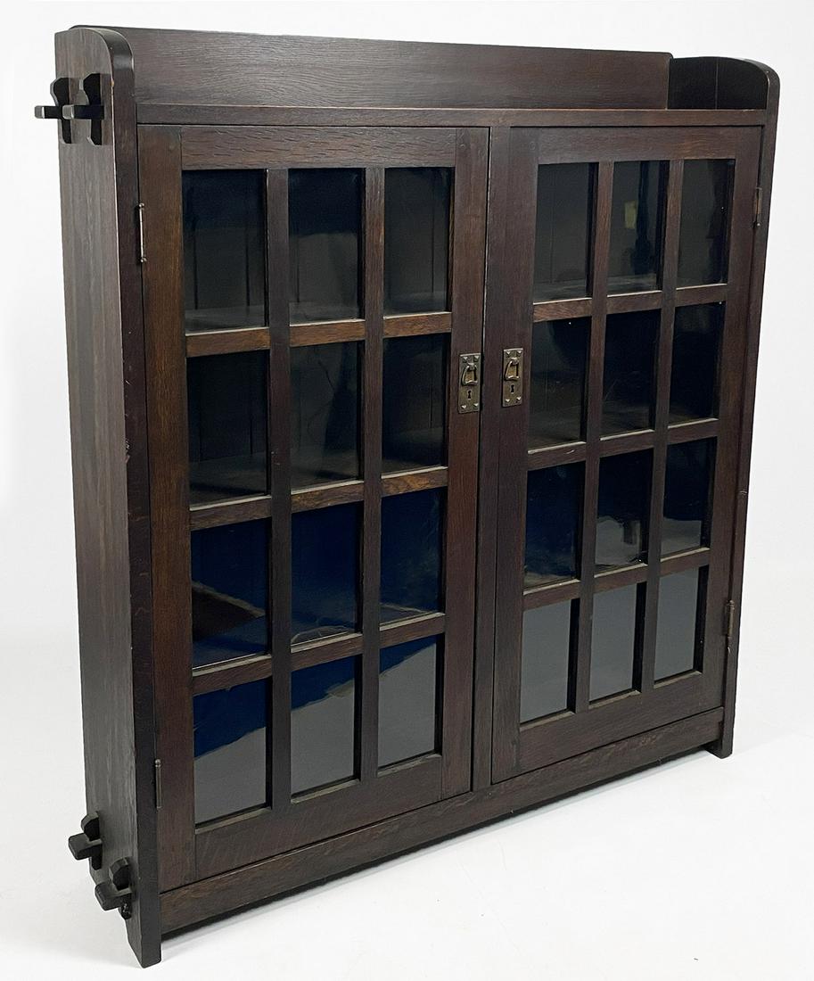 ARTS AND CRAFTS STICKLEY ONANDAGA OAK BOOKCASE: c. 1903, No. 550, unmarked L & J.G. Stickley, in untouched condition with rich color gallery to top, pair of glazed doors, copper hardware, and keyed tenons; vertical backboards, 56.5"h (incl