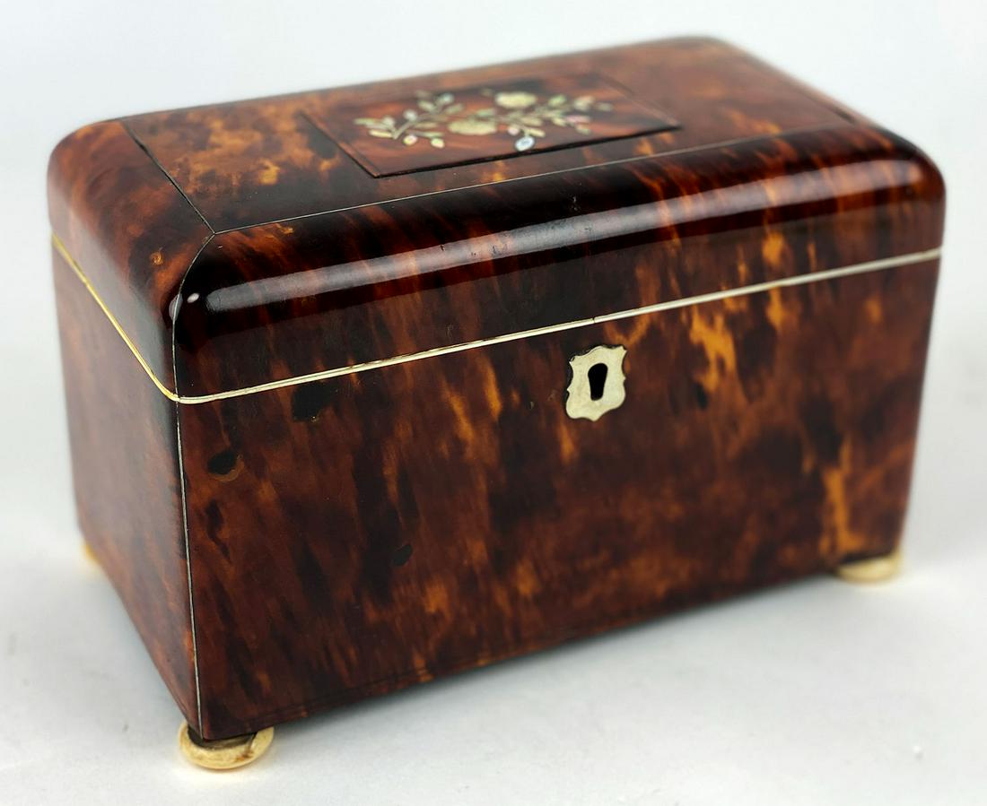 ENGLISH REGENCY INLAID SHELL TEA CADDY: mother-of-pearl floral inlay on lid framed with thin silver inlay; interior has two lidded compartments with bone pulls, bone inlay to interior and bone bun feet; 5"h; 7.5"w; 4"d