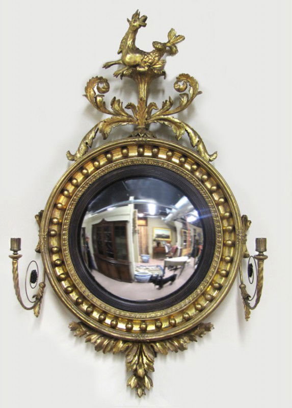 CLASSICAL CARVED GILTWOOD CONVEX MIRROR: carved sea horse and scrolling acanthus leaf crest, candle arm to each side, 43"h; 22"diameter