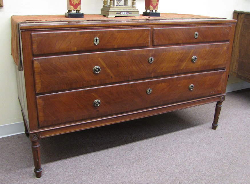 OVERSIZED ITALIAN NEOCLASSICAL WALNUT VENEERED COM: quarter grain veneer top with cross banded edge, 2 side by side drawers over 2 drawers, on tapered stop-fluted legs, 37"h; 60.5"w; 23"d