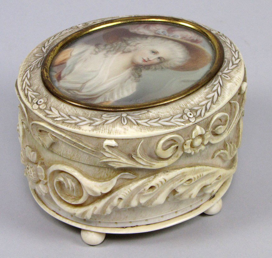 small 19TH C. FRENCH CARVED IVORY OVAL JEWEL BOX: top with inset oval painting on ivory of woman with pink feathered hat, sgn, Dubois the sides with carved raised floral and scroll elements, on ivory ball feet, 3"h, 4.5"l