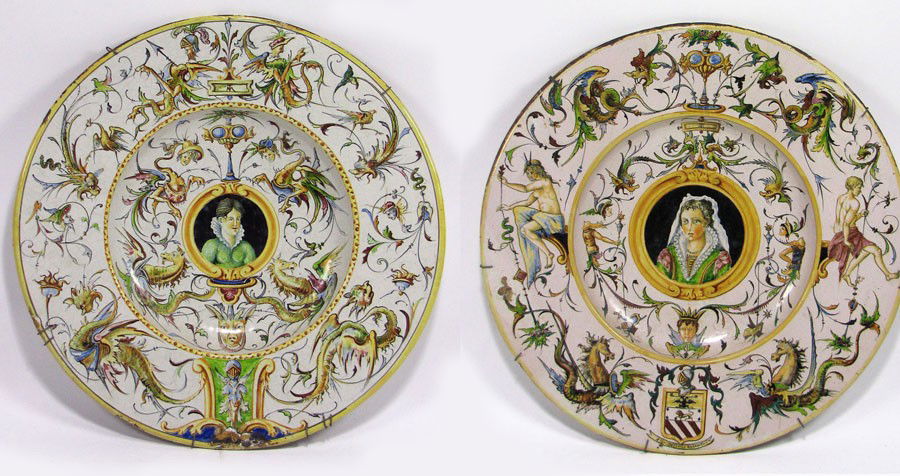 NEAR PAIR OF LARGE EARLY ITALIAN TIN-GLAZED CHARGE: centered portrait of a woman, bordered with dragons, birds, masques and sea monsters; the other, centered portrait of woman with veil on head, bordered with figures, dragons, sea creatures, masques, c