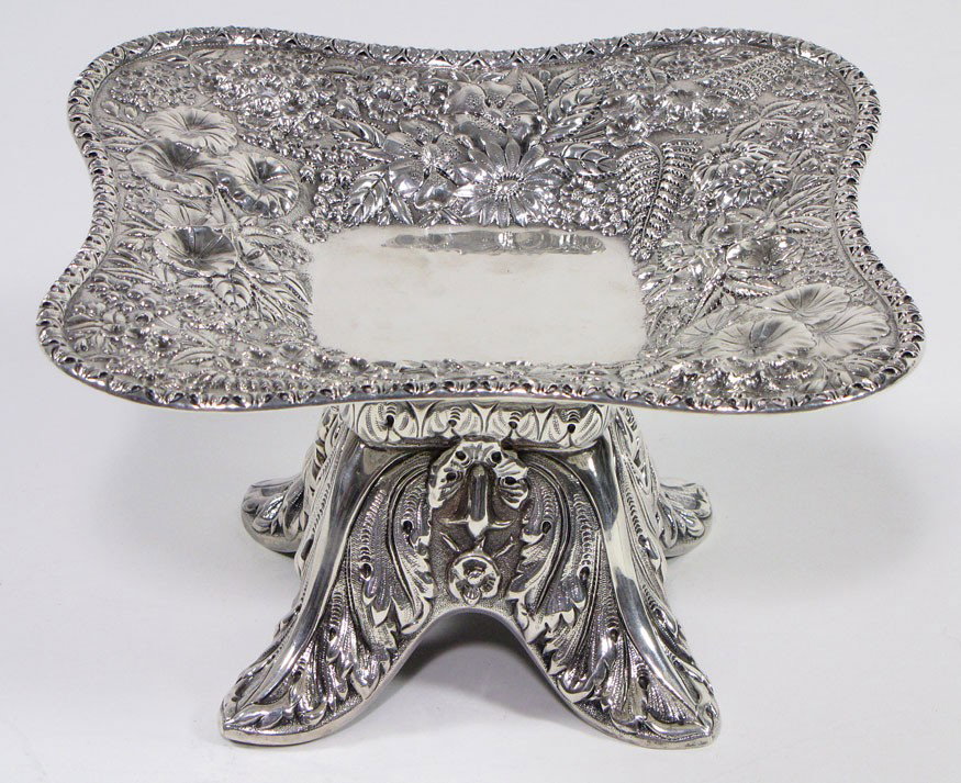 19TH C. STERLING SILVER REPOUSSE SHAPED FOOTED COM: marked: S. Kirk & Son, 11 OZ square shaped top elaborately decorated with flora and fauna surrounding clear center, base decorated with deep repousse foliage, on four molded legs, 5"h; 8.5" square; 22