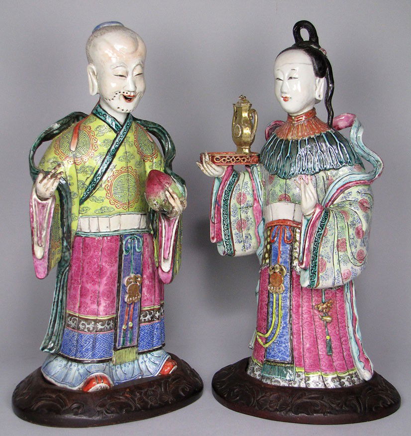 PAIR OF CHINESE FAMILLE ROSE PORCELAIN FIGURES: Qianlong, c. 1775 elaborately robed Immortals, a standing man, the other a woman holding a tray, 15"h, on shaped wooden stands Estate of Mimi Houghton, Beacon Hill, Boston Officers and supercargoes of
