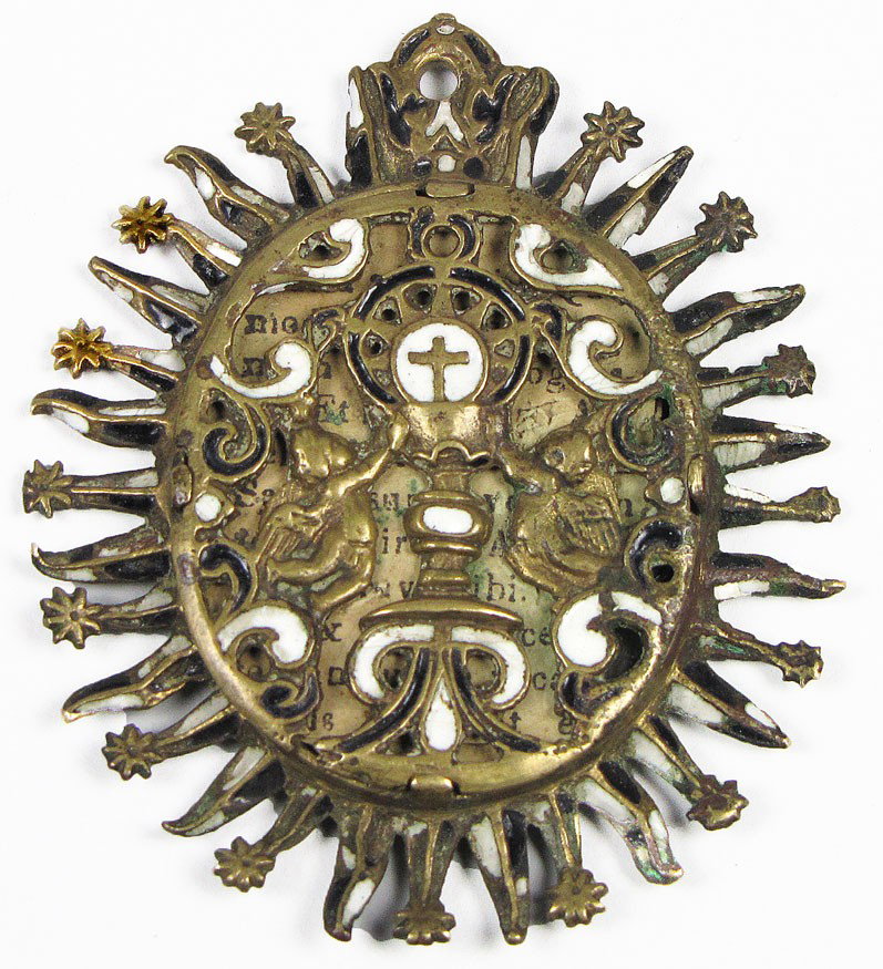 17TH C. SPANISH COLONIAL BRONZE AND ENAMEL RELIQUA: pair of angels saluting a cross, enclosed in a oval sunburst with enamel and bronze rays, 3"h; 2.5"w Estate of Mimi Houghton, Beacon Hill, Boston