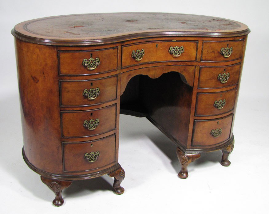 ENGLISH EDWARDIAN-STYLE KIDNEY-SHAPED LADIES DESK: molded edge with brown tooled leather top (rough), double banks of graduated drawers, on shell-carved legs, 32'h; 48"w; 24"d