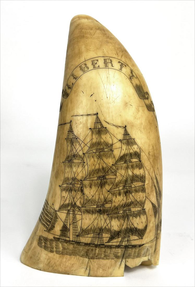 LARGE 19TH C. SCRIMSHAW WHALE TOOTH, 1838: three-masted ship at full sail, banner above LIBERTY; the reverse with initialed and dated banner 18 R. H.S. 38 above a compass star, 6.75"; base 4" From t