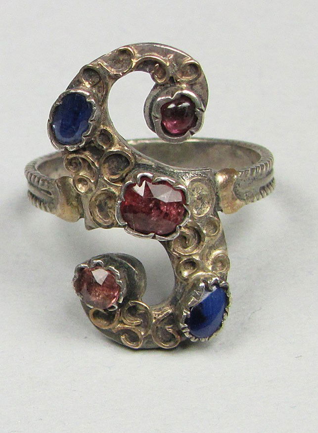 ARTS AND CRAFTS SILVER AND GOLD RING: raised and hammered design gold S set with blue and pale red stones Estate of M. Nelson, South Natick, MA
