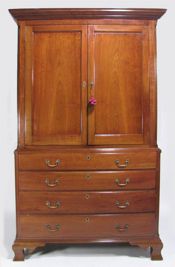 18TH C. CONNECTICUT CHIPPENDALE CHERRY LINEN PRESS: two-part, bold flared cornice over case with double flat panel doors; the lower case with four graduated drawers, both parts with fluted corner columns, on ogee feet, 83”h; 48”w; 22”d Prov.: a N