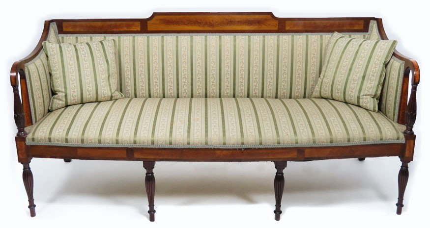 NEW HAMPSHIRE SHERATON INLAID MAHOGANY SOFA: 19th c., crest with tablet of three of flame-birch panels and barber pole string inlay, arms with reeded and leaf-carved supports, apron with conforming inlay, on four turned and reeded legs, 35”h; 