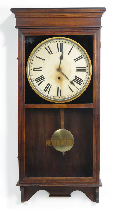 VICTORIAN WALNUT REGULATOR WALL CLOCK: molded and flared cornice, fluted sides and with glazed door, dial with Roman numerals and signed, Made by Sessions Clock Co. Forestville Conn. U. S. A., 38.5”h; 17”w