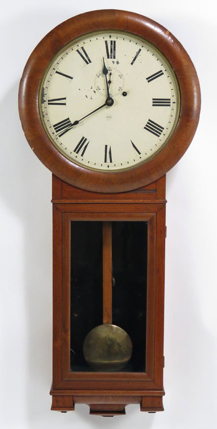 19TH C. SETH THOMAS WALNUT REGULATOR CLOCK: rounded dial frame, dial with Roman numerals and upper second hand, marked in center, ST, molded drop base with glazed door, 37”h Prov.: a New Jersey Collector