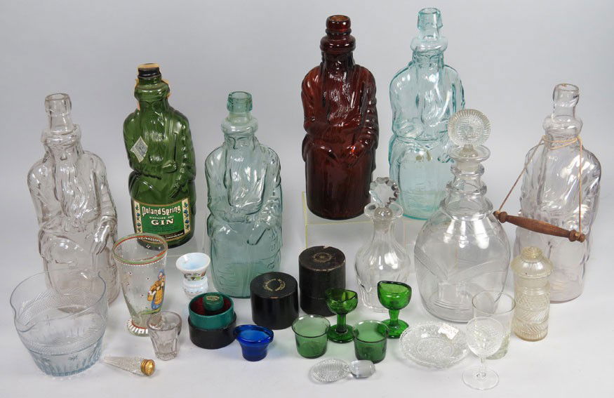 GROUP OF VARIOUS EARLY GLASSWARE: a large and a smaller decanter; wine rinser; eye cups, some colored; shot glasses; (2) measures in cases; and (6) Poland Springs ‘Moses’ bottles