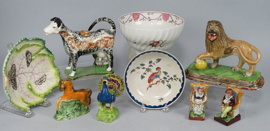 (on 9) GROUP OF EARLY ENGLISH CERAMICS: pair of miniature seated figures; peafowl figure; a horse; a Prattware cow creamer; a lion; a Newhall bowl; peafowl soft paste saucer; and a leaf-form dish Estate of a Madison, New Jersey collector