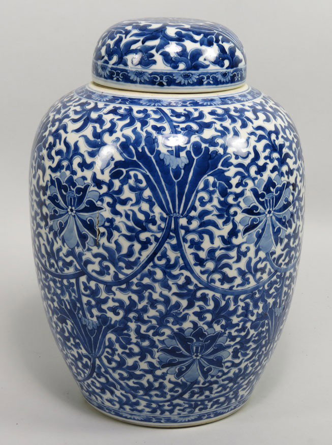 CHINESE BLUE AND WHITE PORCELAIN COVERED JAR: possibly of the Yeng Chen period overall stylized floral design, double blue ring on bottom old auction label glued to bottom reads: Probably Yung-Cheng 1773...., 14”h