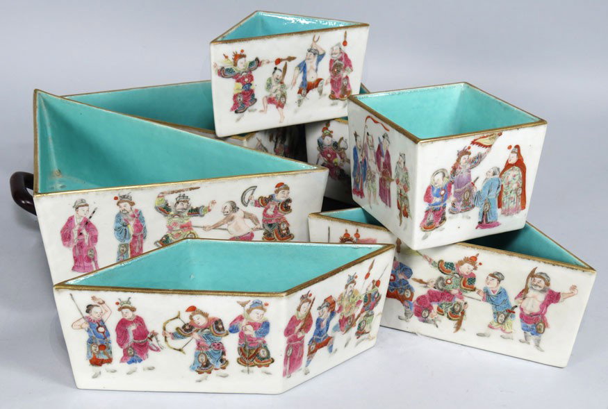 UNIQUE CHINESE ROSE FAMILLE SWEET MEATS SET: 18th c., consisting of seven various figural decorated geometric shaped units fitting into a difficult puzzle, turquoise interiors, set in a wood tray, 11.5” square The units are decorated with 108 