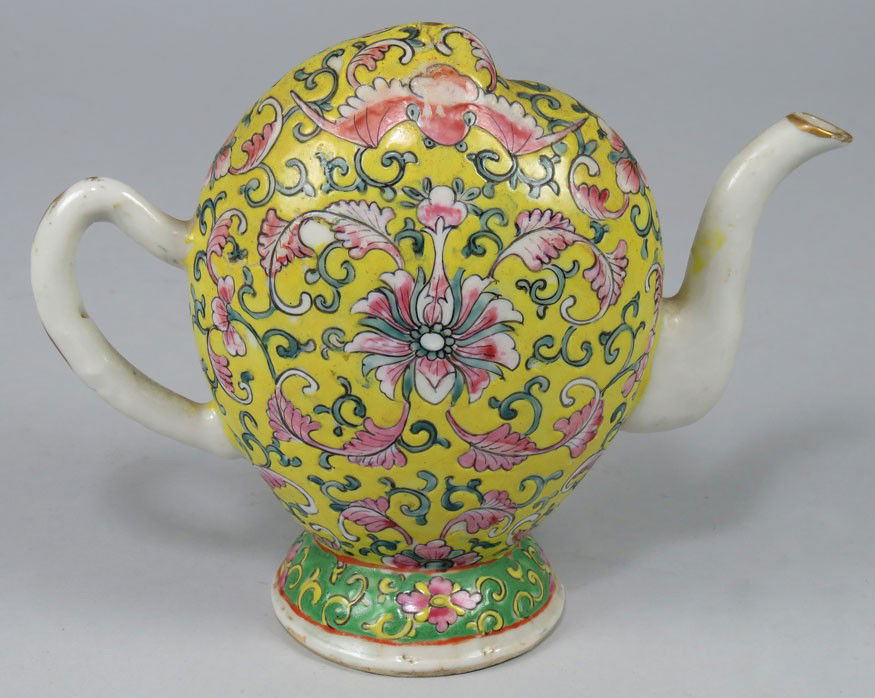 CHINESE KANGXI ‘CADOGAN’ WINE EWER: peach-form with famille rose floral and bat decoration on yellow ground 6”h; 7.5” handle to spout Lord Cadogan (1676-1726) took a fancy to these strange puzzle ewers and imported them into England