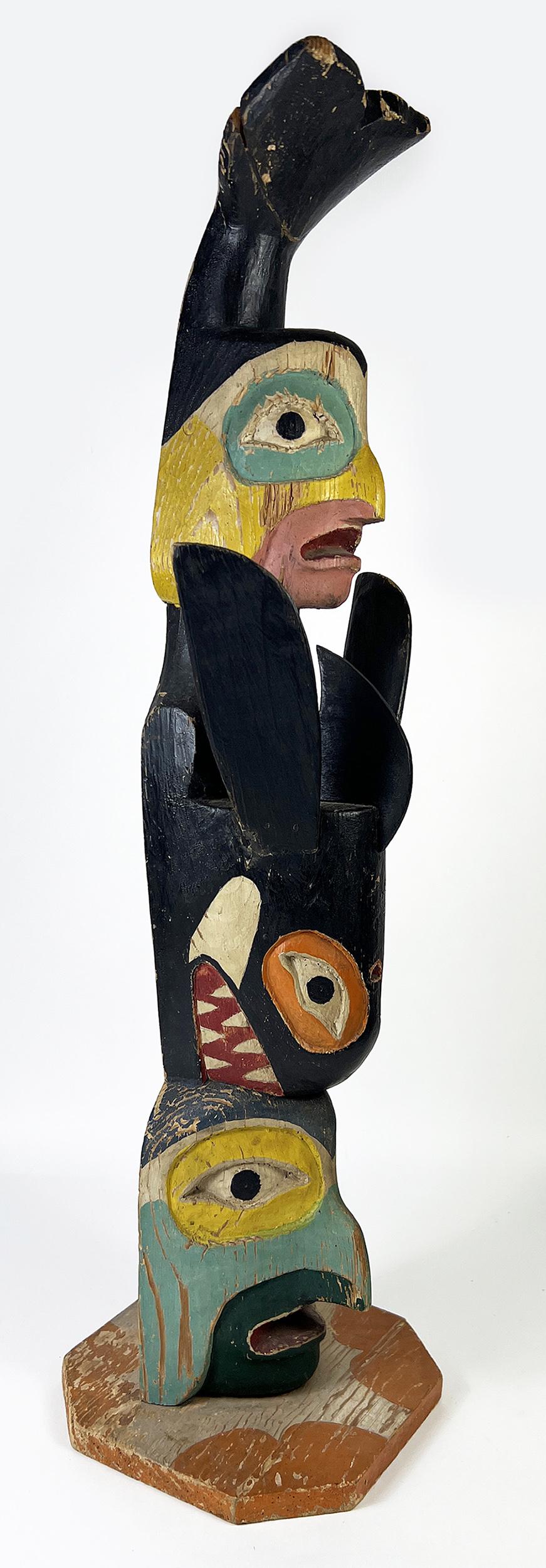 NORTHWEST COAST CARVED AND PAINTED MODEL TOTEM POLE: early 20th c., stacked figures, full bodied diving whale and two hawk-men; on painted flat base; newspaper remnant pasted on back; 25" h; base is 6.5" deep NOTE: Apologies, we cannot approve bidders d