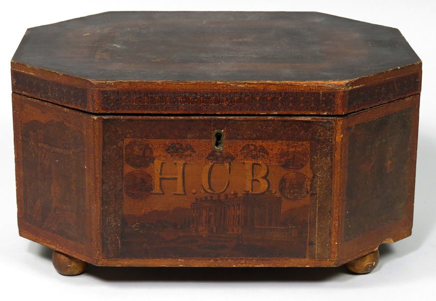 EARLY 19TH C. OCTAGONAL DECORATED SEWING BOX: in old color, initialed HCB on front, with architectural scenic panels, compartments lined with old prints, gold ball feet, 6.75”h; 12.75”w; 8.75”d Ex Forbes family, Cambridge, MA