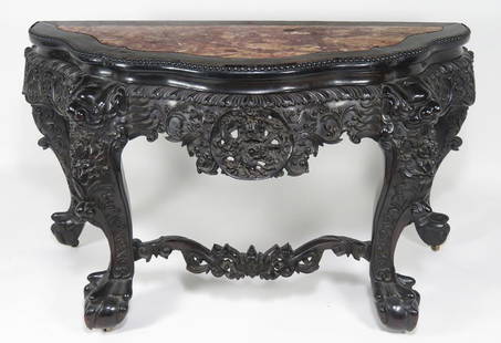 19TH C. CHINESE SERPENTINE CARVED ROSEWOOD CONSOLE: shaped demi-lune top with inset rouge marble, apron with ornately pierce carved centered dragon medallion, carved foo dog heads cap the front cabriole legs, joined by stretchers and ending in large ba