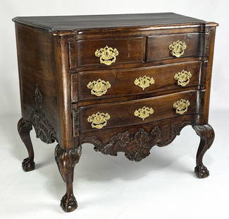 SMALL-SIZED PORTUGUESE ROCOCO SERPENTINE COMMODE: molded top over three serpentine drawers with ornate brass hardware; shaped, shell carved apron; sides also shell carved; acanthus caved knees; cabriole legs ending in ball and claw feet; 33"h; 3