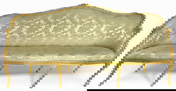 ENGLISH GEORGE III CARVED GILTWOOD SOFA: shaped back and arms; serpentine front; eight floral carved cabriole legs; back 39”h inc. carved flower; 78”w; 28”d Prov.: Sotheby’s London October 31, 2017, lot 284
