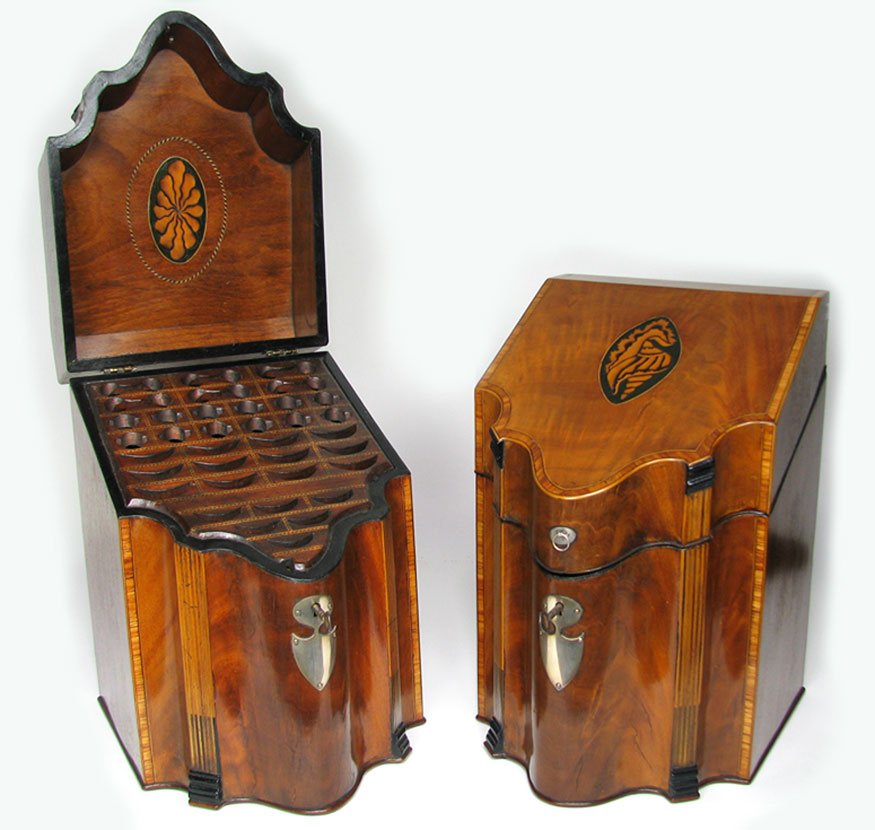 FINE PAIR OF HEPPLEWHITE INLAID MAHOGANY KNIFE BOX: c. 1795-1810, hinged top with banded inlay and oval conch shell inlay on green ground, interior of lid with oval inlay, the serpentine front with chased shield-form silver escutcheon flanked by inlaid