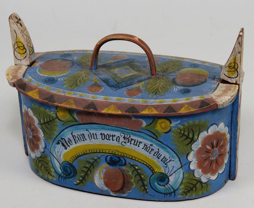 NORWEGIAN OVAL ‘TINA’ BOX: late 19th c., typical Scandinavian paint decoration on blue field, tall ears at the sides, inscription to front, 5.75"h; 8"w; 4.5"d