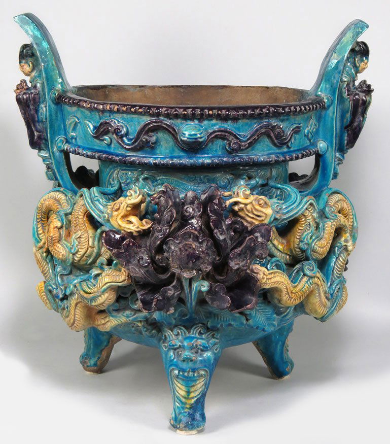 CHINESE MING LARGE GLAZED EARTHENWARE CENSER: 16/17th c., Shanxi province, archaic tripod-form with various colorful lead glazes and ornate relief decoration, each handle with a Buddhist monk, the rim decorated with Buddhist treasures, the front