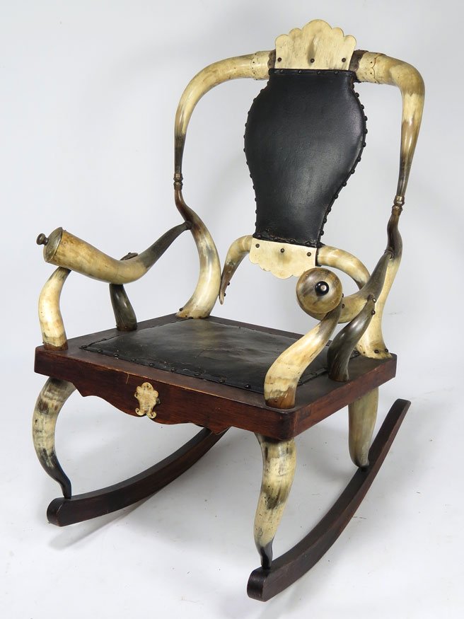 19TH C. STEER HORN ROCKING ARMCHAIR: unusual shaped crest, panel back, with reverse shaped arms and fitted seat, 42h; 25"w"