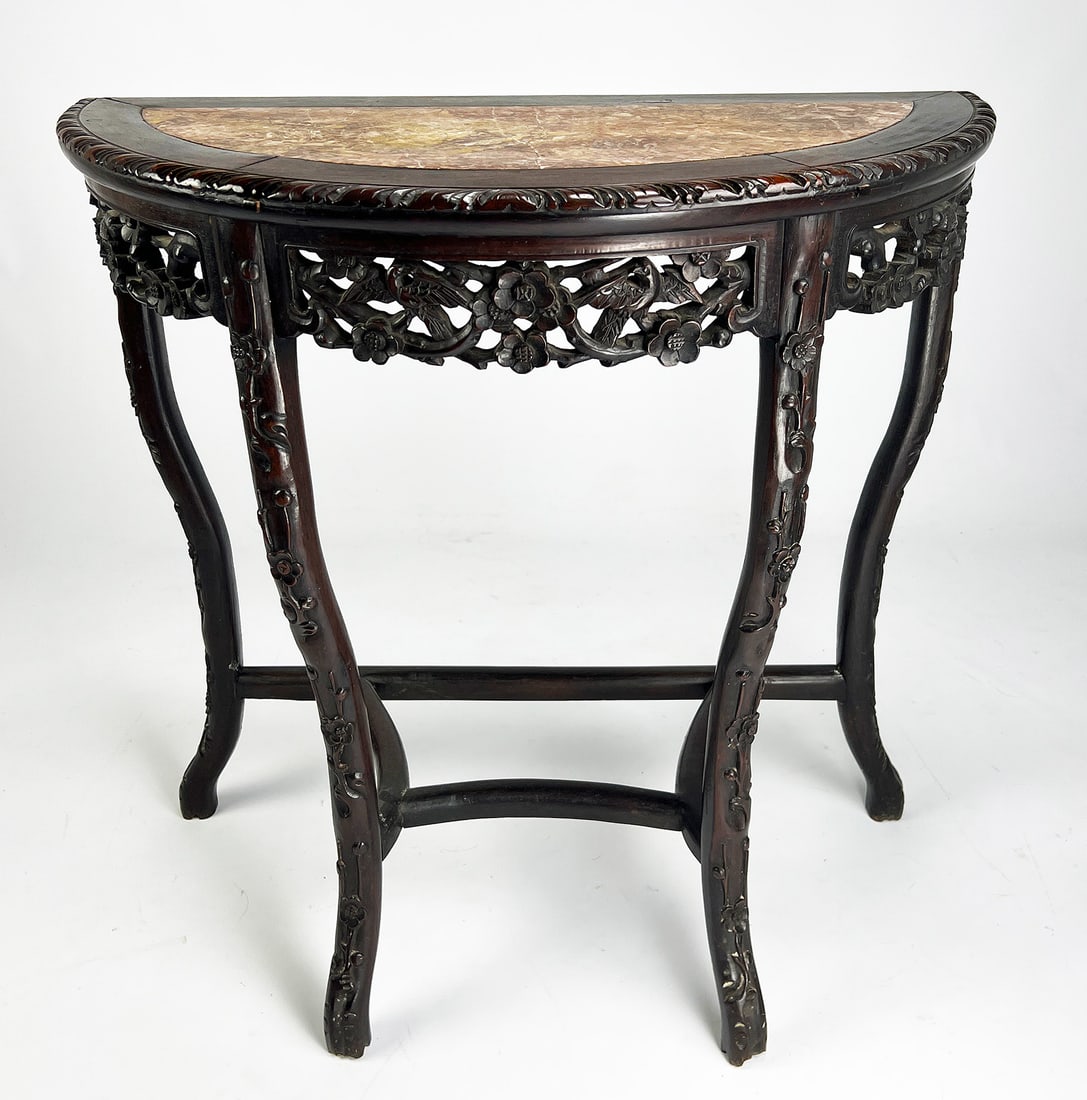 CHINESE CARVED HARDWOOD CONSOLE TABLE: 19th c., demilune-form, conforming inset marble top; pierced apron; cabriole legs joined by stretcher; 32"h; 32"w; 16"d NOTE: Apologies, we cannot approve bidders during the auction.