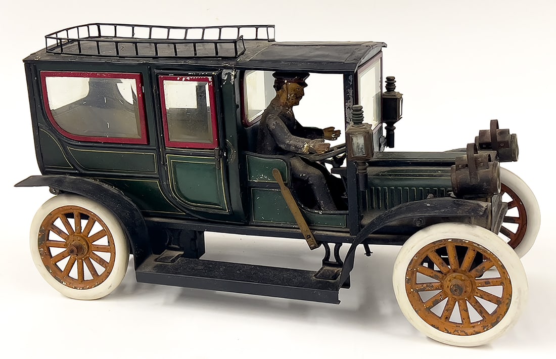 LARGE CARETTE TIN TOY LIMOUSINE: Georges Carette (Germany) c. 1910 wind-up with key; lithographed body and painted driver; rubber tires and glass windows; side lanterns; brake lever; 15.5"long; 9"h From the estate of Alan V