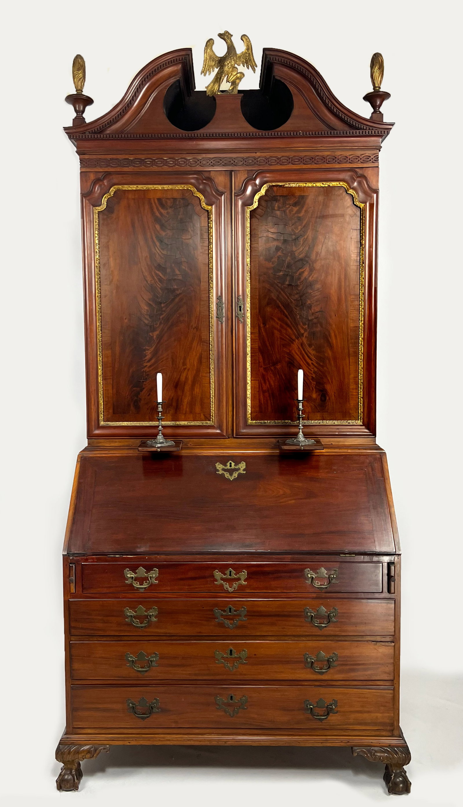 NEW YORK CHIPPENDALE MAHOGANY SECRETARY, COOLIDGE FAMILY: c. 1750-1770, three-part, dense San Domingo mahogany, poplar secondary wood; full-bonnet top with dental molding and original carved and gilded flame finials, gilded carved eagle to center; mid sectio