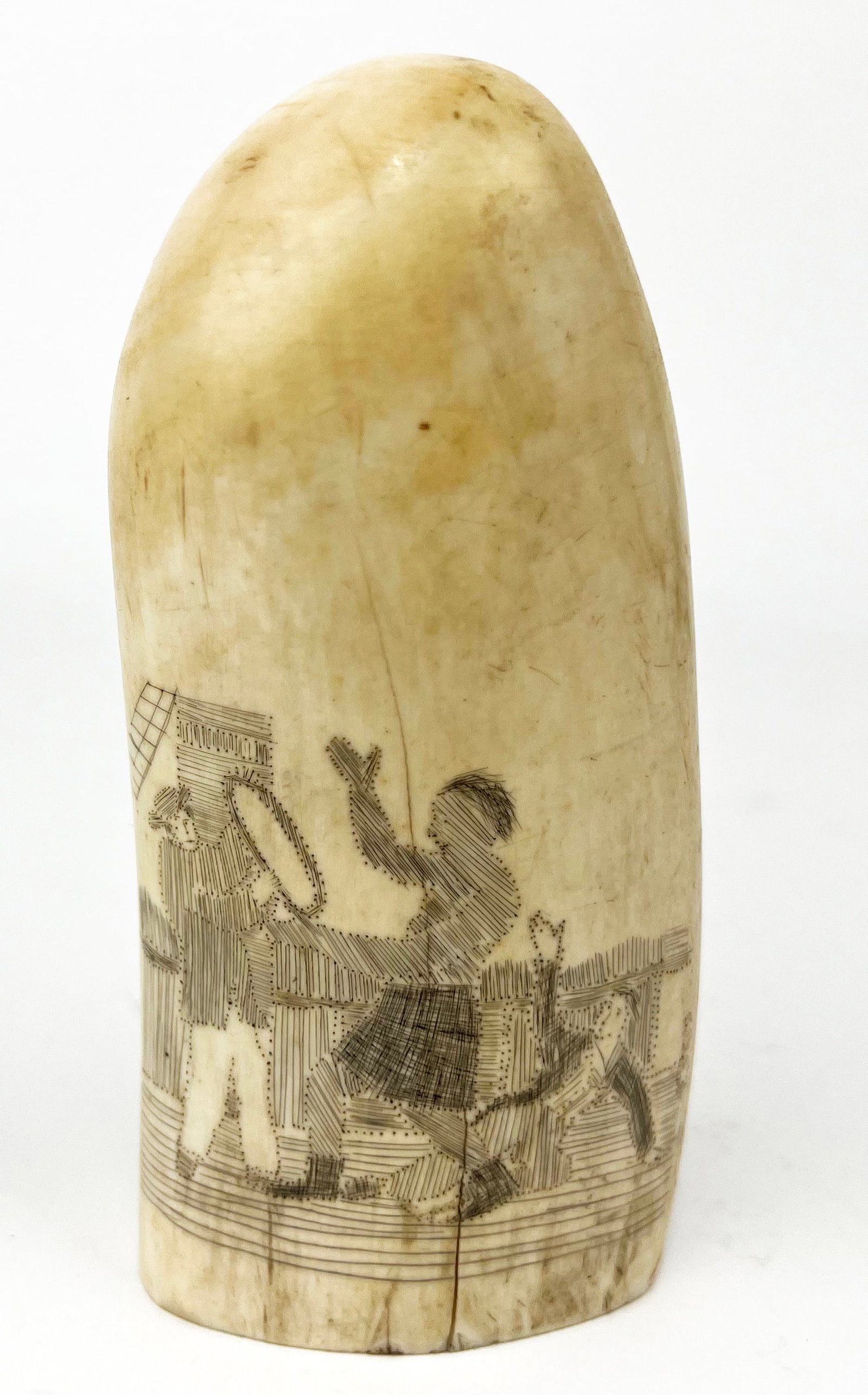 19TH C. SCRIMSHAW WHALE TOOTH: decorated with a fully-rigged ship; the reverse with three figures on deck in a brawl (two sailors, one protecting himself with shield, the third an indigenous man); 5.5"; 2.5" base NOTE: Apologies, w