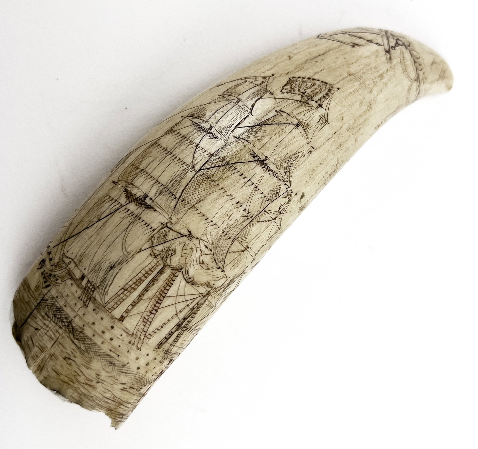 19TH C. SCRIMSHAW WHALE'S TOOTH: the tip circled with a band and an anchor and dated 1809 above a war ship at full sail; the reverse with a woman wearing a bonnet with her hand on her heart MARIE; 6" The collection of a New York gent