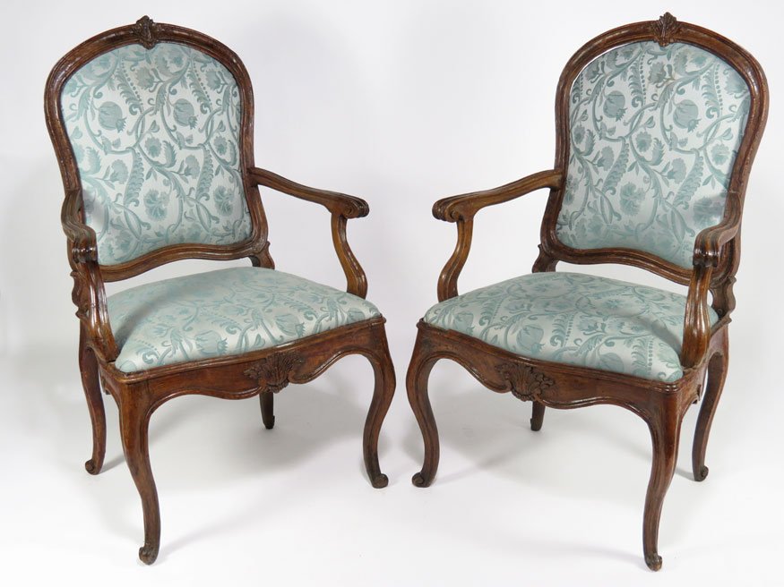 PAIR OF 18TH C. ITALIAN CARVED WALNUT ARMCHAIRS: carved leaf to crest rail and apron, open arms with scrolling knuckles, cabriole legs, upholstered back and seat, 42”h; 25”w