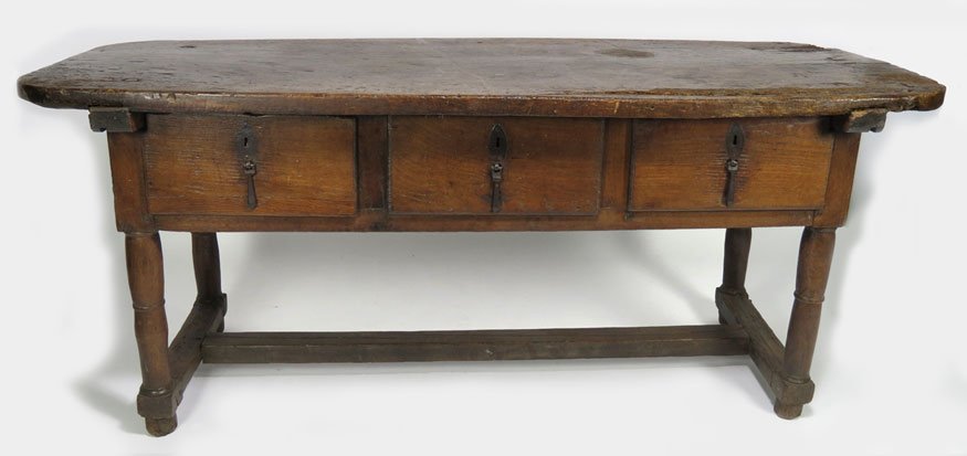 17TH C. SPANISH WALNUT REFRACTORY TABLE: three drawers with original iron drop pulls and escutcheon plates, turned legs joined by H-stretcher, 32”h; 77.5”w; 29.25”d