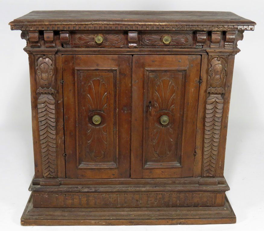 ITALIAN BAROQUE CARVED WALNUT CREDENZA: rectangular top with dental molding, two small drawers to freize, above pair of carved cupboard door flanked by carved imbricated pilasters, step-molded base, 38”h; top 41”w; 19”d