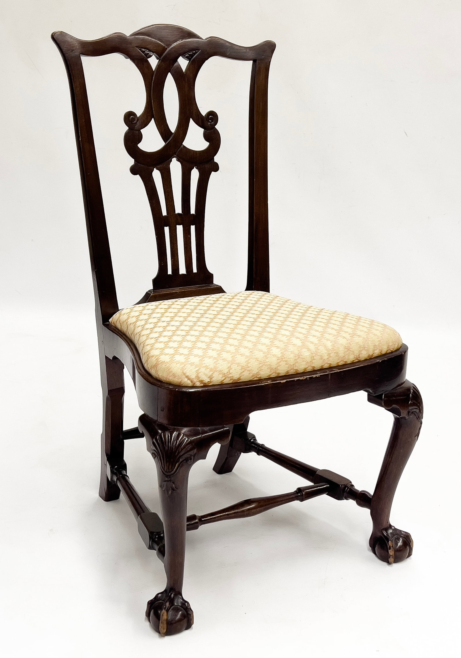 NEWPORT CHIPPENDALE MAHOGANY, BALLOON-SEAT SIDE CHAIR: shell-carved knees; cabriole legs joined by block and turned stretchers; ball and claw feet; slip seat; back 38"h; seat rail 17"h, seat width 21"w NOTE: We cannot approve bidders during the auction. P