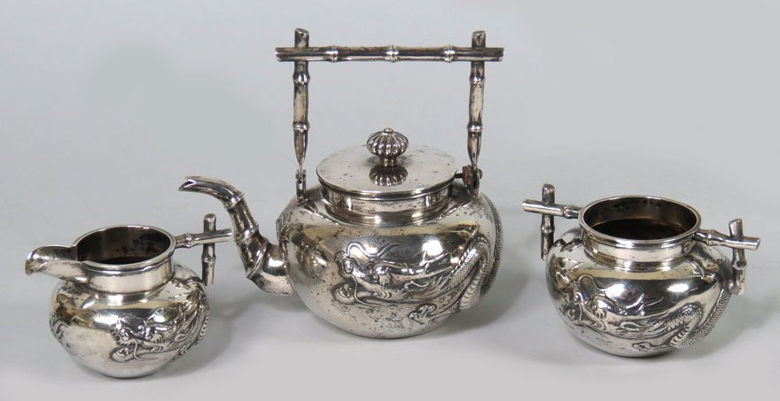 3-PIECE CHINESE SILVER TEA SET: maker: Wang Hing, Hong Kong, late 19th, early 20th c. three hallmarks: a Chinese glyph, WH; and 90 with raised dragon design, teapot 6”h incl. bamboo-form handle; creamer and sugar, 21 troy oz. tota