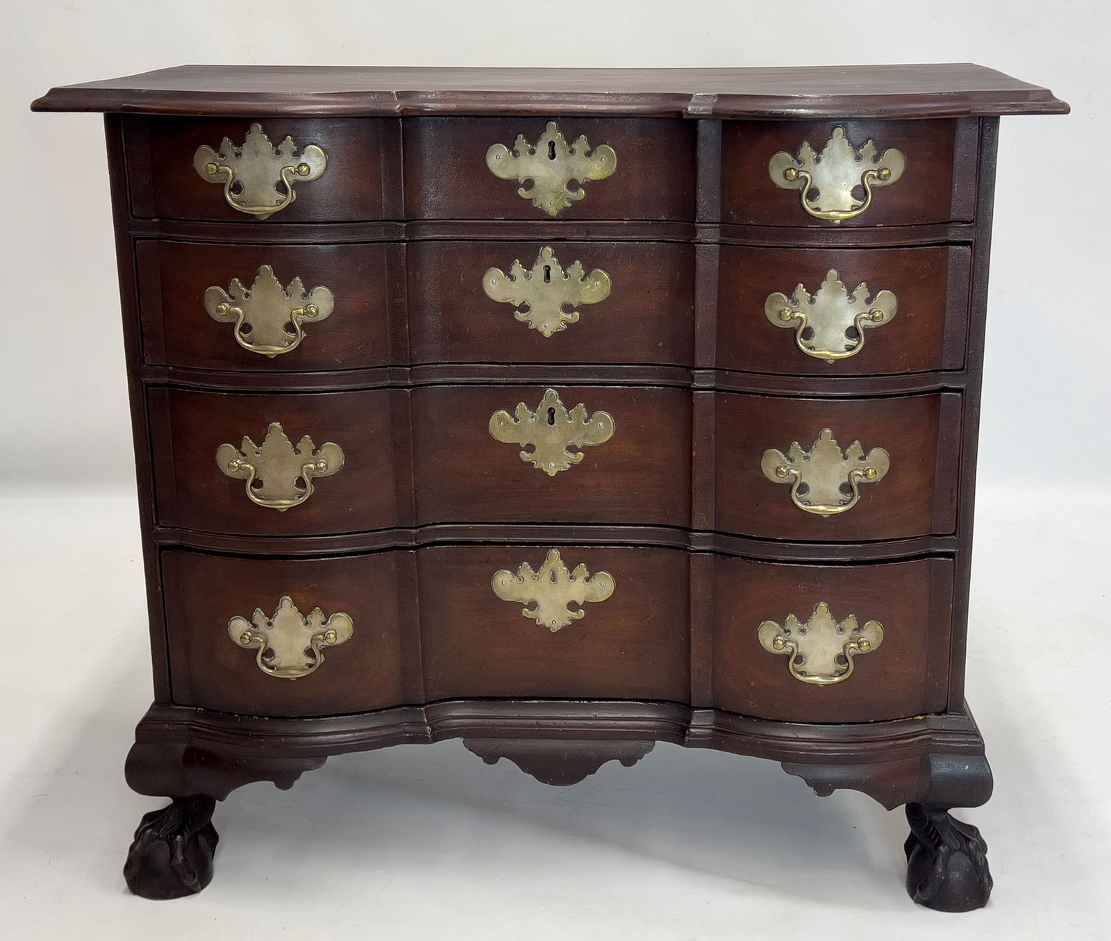 MASSACHUSETTS CHIPPENDALE BLOCK-FRONT MAHOGANY CHEST: c. 1760; old color, shaped molded edge top; four conforming graduated drawers with original silvered, bat wing brass; conforming side carrying handles; bold ball and claw feet; 33"h; case 33"w, 17"d;