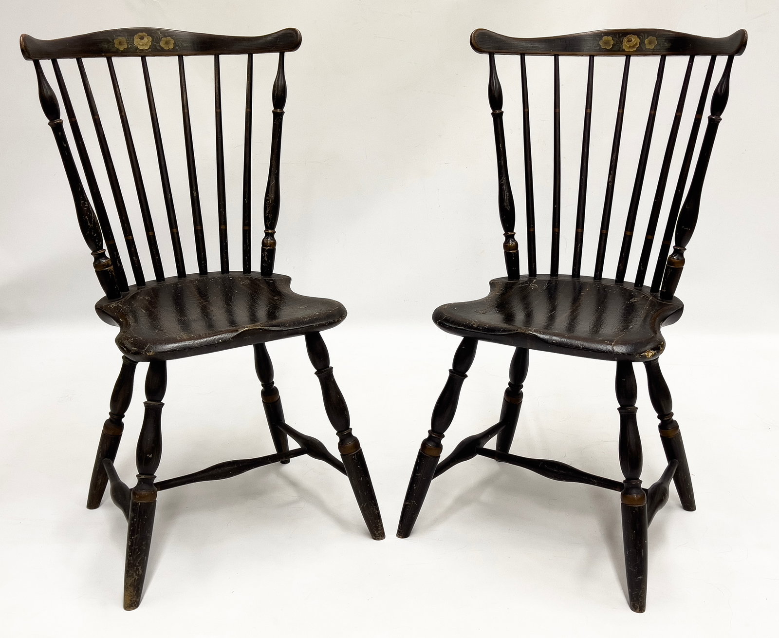 PAIR OF PAINT DECORATED WINDSOR FAN-BACK SIDECHAIRS : 7-spindles; painted flowers to crestrail; grain painted seats; bold turned legs joined by H-stretcher; 36.5"h; seat 18"h, 6"w