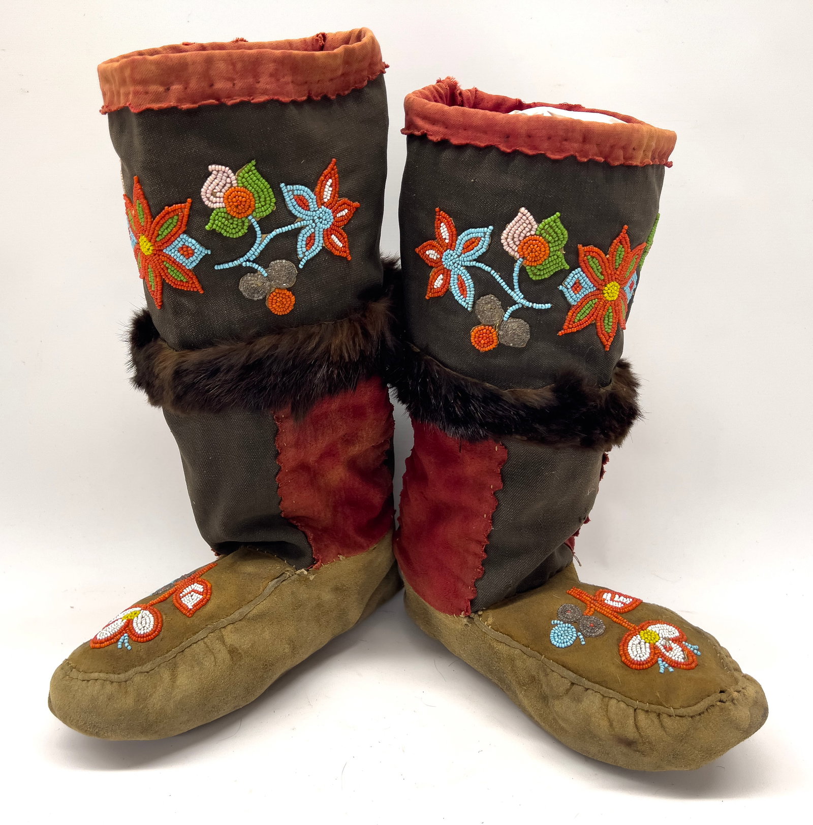 NATIVE AMERICAN ASSINIBOINE/NAKODA BEADWORK WINTER BOOTS: floral beadwork on leather, suede and fur band; 14"h; foot is 11" long and 4"w The Assiniboine, who called themselves Nakoda, were crucial to the North American fur trade, particularly for the