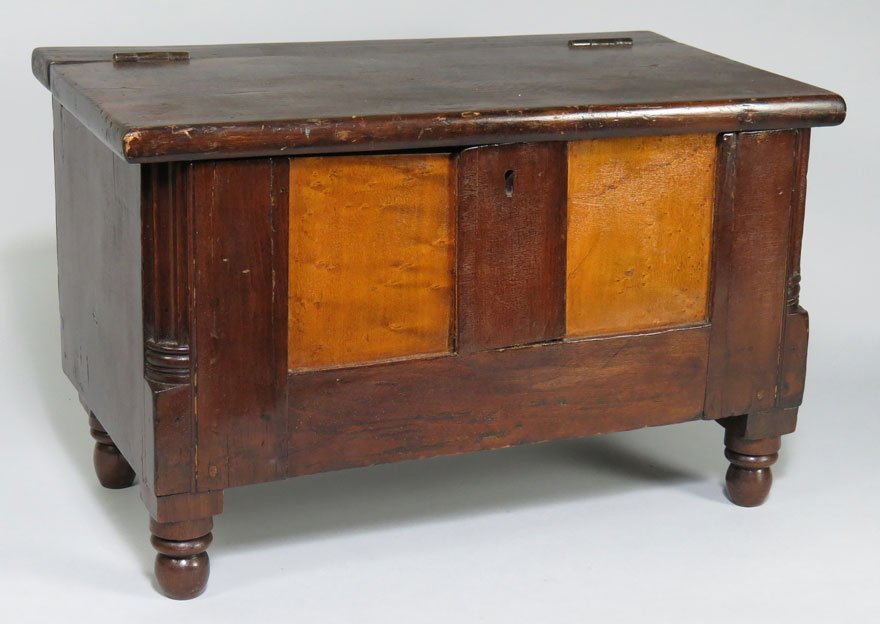 NEW ENGLAND MINIATURE BLANKET CHEST: early 19th c., prob. Rhode Island, walnut, maple front panels, fluted corners, block and turned legs, 12”h; 19.5”w; 10”d