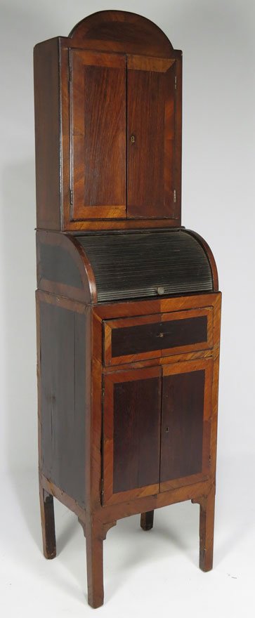 SMALL-SIZED ITALIAN 2-PART TAMBOUR DESK: cupboard sits atop desk with tambour roll, above drawer and pair of cupboard doors, 62”h; 16”w; 13”d