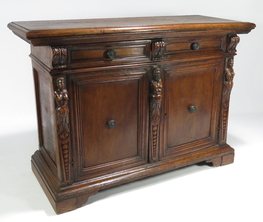 ITALIAN BAROQUE CARVED WALNUT CREDENZA: constructed with old elements, two drawers over pair of cupboard doors centered by carved male term and flanked by female terms, flat molded base, 39.5”h; 56.5”w; 22.5”d