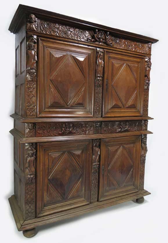 FRENCH RENAISSANCE WALNUT TWO-PART CABINET: figural and floral carved cornice above pair of doors with raised diamond shaped panels flanked and separated by female terms mounted on masques, bottom part with pair of frieze drawers above pair of 