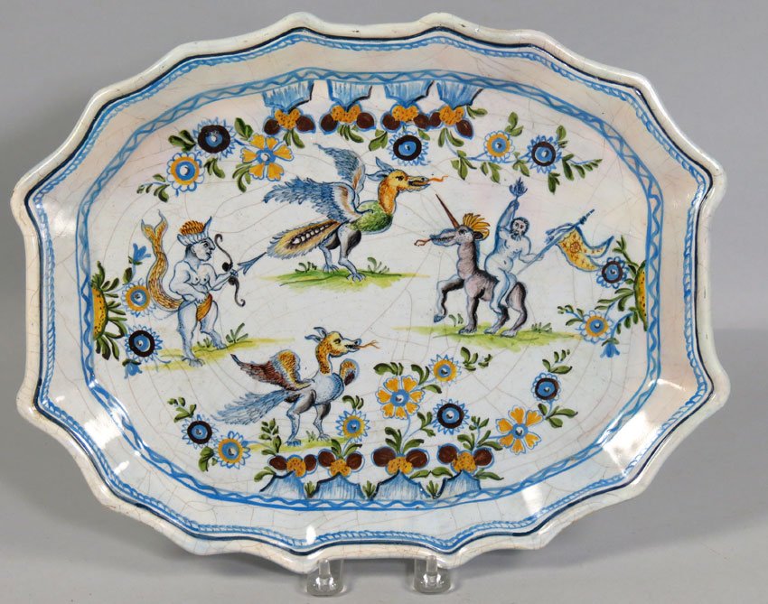 TIN-ENAMELED EARTHENWARE PLATTER: Spanish or Italian, 18 c., mark on reverse: AA centering crossed arrows with circle shaped rectangular-form decorated with man on unicorn, two dragons, and a mythological man/beast, 14 by 11""