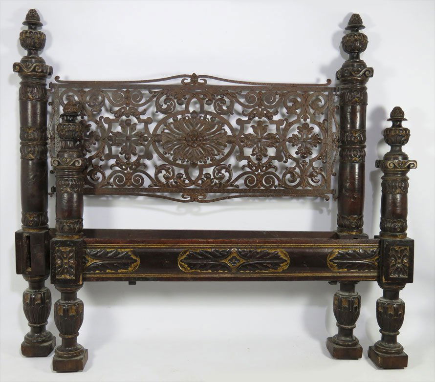 ITALIAN CARVED WALNUT BED: Neapolitan, open-work wrought iron headboard, heavy acanthus leaf carved and turned posts with large urn finials, gilt embellishments, carved side rails, double size, 62.5"h; 63"w